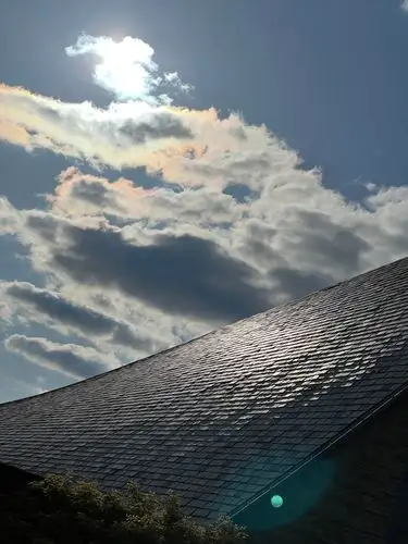 Sunlight glints off a beautifully textured roof.